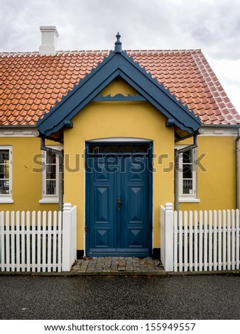 Small characteristic yellow house in the center of Skagen in jutland