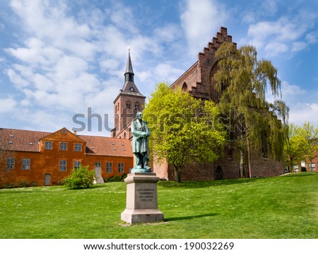 Sculpture statue of Hans Christian Andersen in front of sct Knud cathedral, Odense Denmark