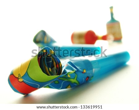 part blowers and party poppers on white background