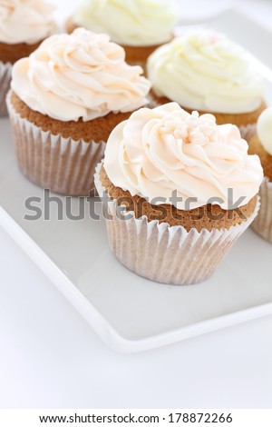 frosted cup cakes on platter