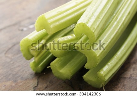 fresh celery sticks on slate background