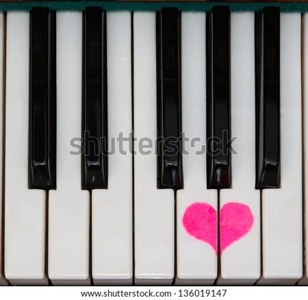 piano keyboard top view with a painted heart
