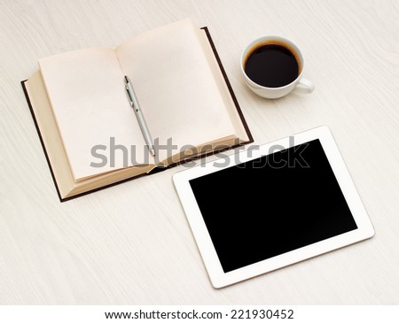 Workplace with a book, tablet and coffee