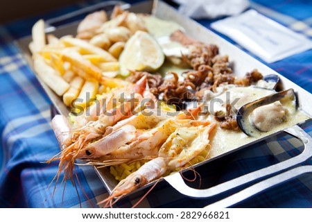 fish and chips plate with prawns, oysters, fries,