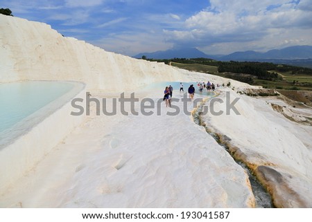 PAMUKKALE, TURKEY - APRIL, 16: Tourists on Pamukkale travertines on April 16, 2014 in Pamukkale, Turkey. Pamukkale, UNESCO world heritage site, nowadays become one of the most visited sight in Turkey.
