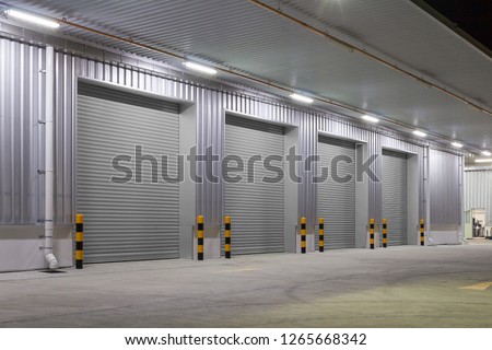 Shutter door or roller door and concrete floor outside factory building  for industrial background.