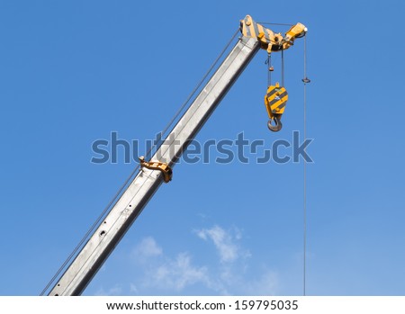 Boom of mobile crane with blue sky background.