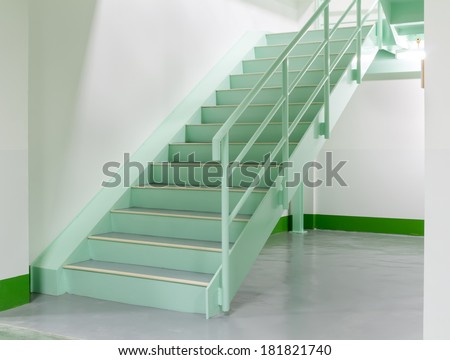 Steel stair in white room.