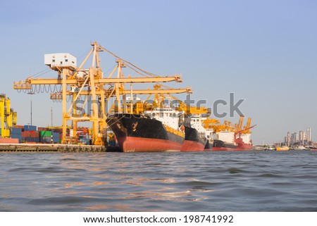 Cargo ship unloading container at port day time Cargo ship unloading container at port day time