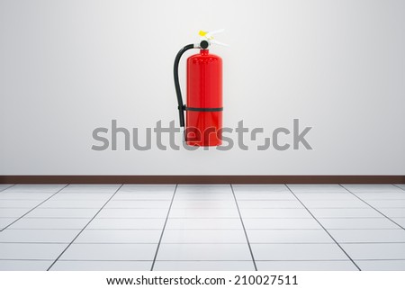 Fire extinguisher on white wall, ready for use.