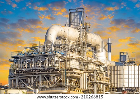 Machinery in Oil refinery plant with blue sky background.