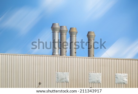 Ventilation system of factory with sky background.