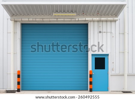Shutter door and steel door outside factory, blue color.