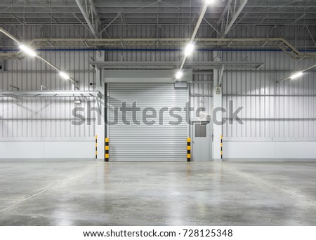 Shutter door or roller door and concrete floor inside factory building for industry background.