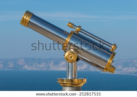 Old golden sightseeing telescope in Marseille, France, 2015