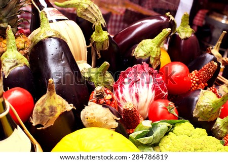 Vegetables and fruits with herbs and wine in a basket