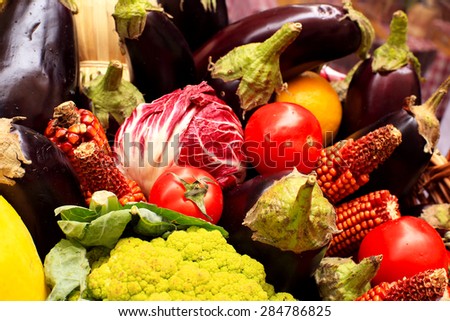 Vegetables and fruits with herbs and wine in a basket