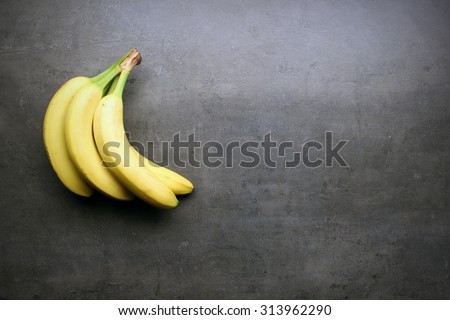 Fresh bananas on kitchen table with copyspace