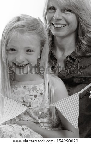 pretty blonde girl and her mother having a cuddle with bunting, isolated on white background in monochrome