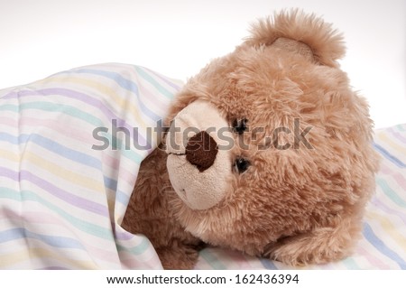 teddy bear in bed isolated on white background