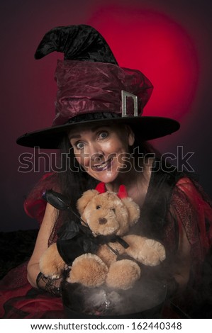 Halloween witch with cauldron and vampire teddy bear, casting spells on dark background
