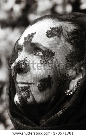 widow in mourning with veil over her face in monochrome