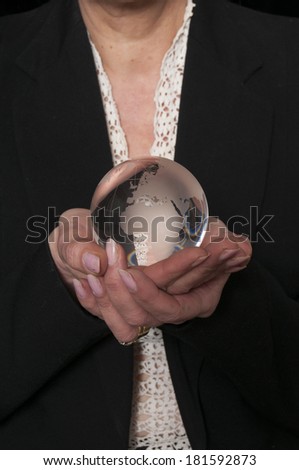 Vintage 1940\'s style woman  holding a glass globe, isolated on black background
