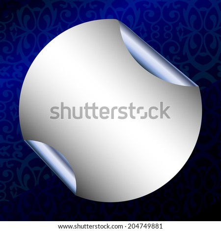 Round silver sticker with rolled edges on dark blue patterned background. Paper for notes. Square backdrop.