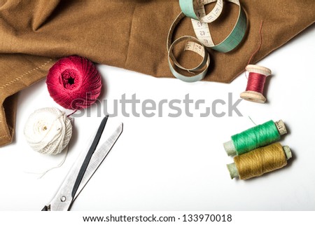 accessories for sewing with a rough cloth on a white background