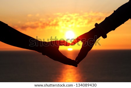 Two Hands Of Lovers On The Background Of Sunset On The Sea