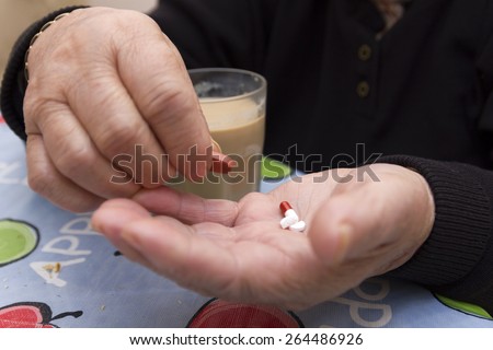 Elderly woman taking her medicine