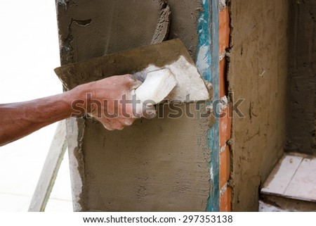 Construction workers working on site. Works at home. Reform facade. Worker wearing the facade of a house.
