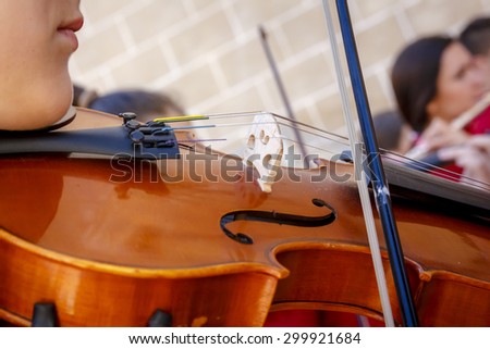 Musician playing violin in the streets. Giving concert violinist abroad. Closeup of a violin. Mariachi brightening event.