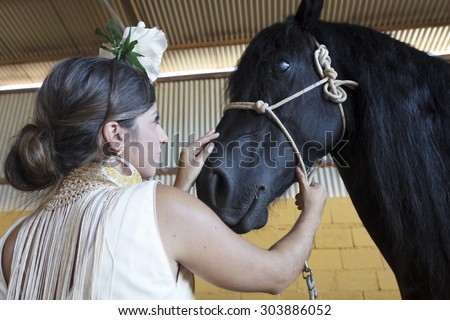 Flamenco dancer with black Arabian horse. Gypsy flamenco and Arabic black horse. Flamenco dancing horses.