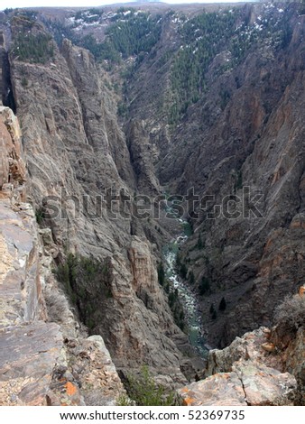 Vertical view of Black Canyon of the Gunnison Colorado Rugged Cliffs and River. Steep cliffs above the Gunnison River rugged rocky canyon. Scenic landscape looking down.