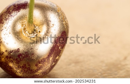 Gold fruits close up on gold background