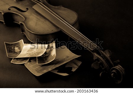 Old  broken violin with photos
