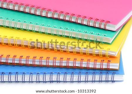 Colorful ring bound books that are isolated on white Background.