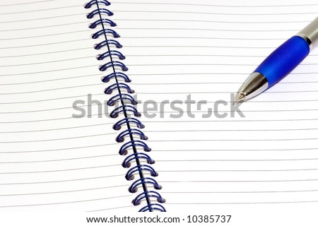 Close up of a blue notepad with ballpen