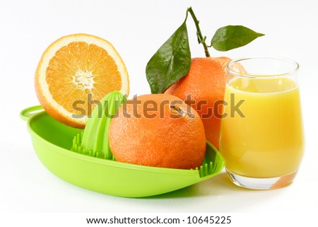 Orange Juice with fruits and a green juicer
