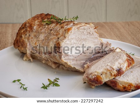 Pork baked with thyme in a cut on a platter