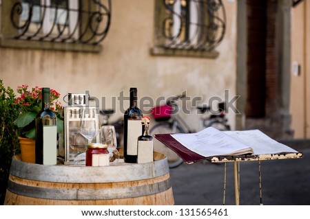 Bottles of wine on a barrel against a Italian restaurant background, August 2012