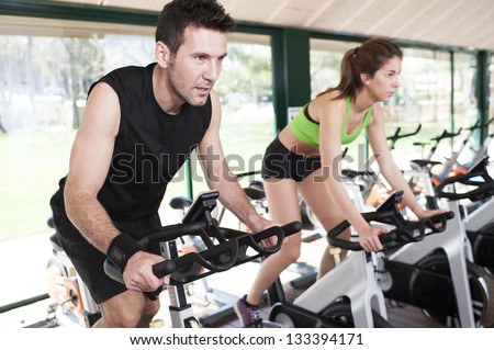 two Friends Are In A Spinning Class At Gym
