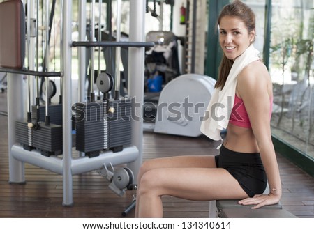 Relaxing after a hard gym session. One young woman\'s portrait after working hard at the gym
