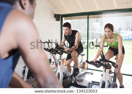 Fitness coach and two friends at a exercise bike class