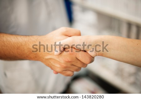 handshake man woman at pharmacy.