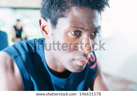 Black man during a stationary bike session at gym