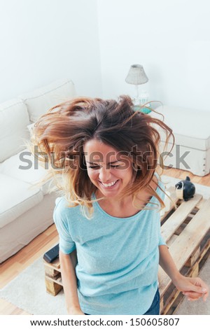 Happy Girl Dancing At Home While Listen Music With Headphones. She Is In Her Home