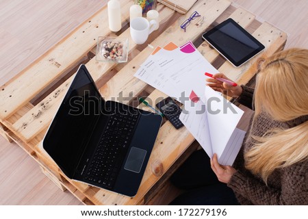 Domestic Economy. Woman Checking Bills At Home