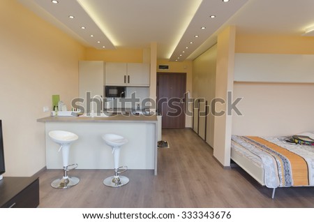 Modern living room with kitchen corner  with modern LED lighting